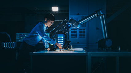Poster - Japanese Development Engineer is Testing an Artificial Intelligence Interface by Playing Chess with a Futuristic Robotic Arm. They are in a High Tech Modern Research Laboratory with Low Key Light.