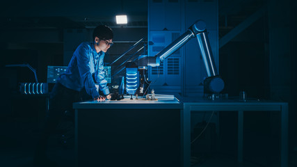 Leinwandbilder - Japanese Development Engineer is Testing an Artificial Intelligence Interface by Playing Chess with a Futuristic Robotic Arm. They are in a High Tech Modern Research Laboratory with Low Key Light.