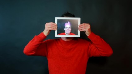 Poster - Portrait of a guy holding a tablet in his hands.