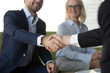 © fizkes - Smiling businessman shaking hand of business partner or candidate