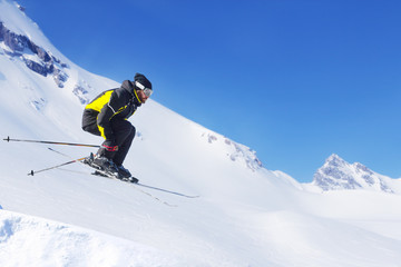 Wall Mural - Jumping skier at mountains