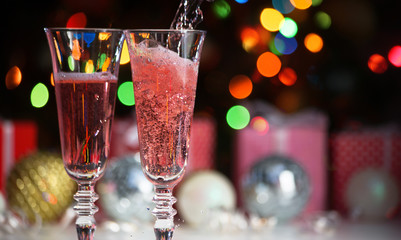 Wall Mural - Beautiful splash of pink champagne glasses and Christmas lights