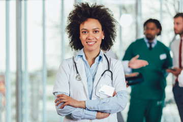 Portrait of african american female doctor on hospital looking at camera smiling.