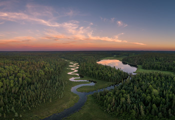 an aerial view of a winding clearwater creek in northwest ontario, canada.