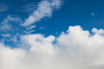 Wall Mural - Background of white cumulus clouds with moon on a blue sky at daylight. Telephoto zoom shoot