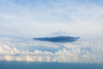 Wall Mural - Background of white cumulus clouds on a blue sky at daylight. Telephoto zoom shoot