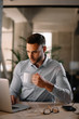 © JustLife - Portrait of handsome businessman working in office and drinking coffee.