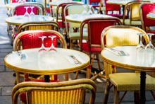 Street View Of A Coffee Terrace With Tables And Chairs In Europe