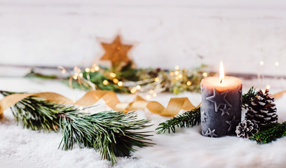 romantic winter and christmas greeting card - burning candle with natural fir and pine cone decorati