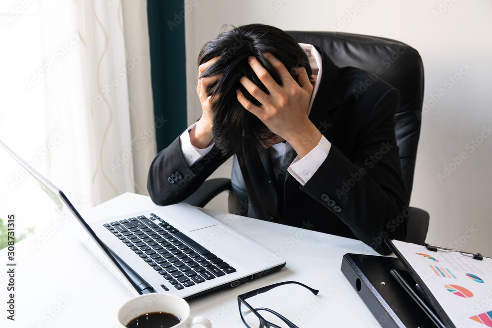 Business man holding his head problems debts in the office Stock Photo ...