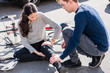 © Kzenon - Helpful young man giving first aid to an injured woman after bicycle accident