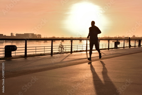 Fotomural Man jogging Outdoors in The Fall on quais de Bordeaux, France