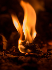 Fire flame burning glowing on black dark background, hot heat energy fuel fire motion pattern abstract texture.