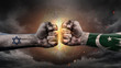 © JustLife - Israel vs Pakistan. Fists with flags. Battle of two countries on sky.