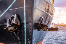 The Nose And Anchors Of A Black Icebreaker Moored In The Port.