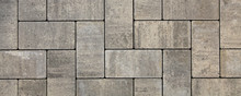 Regular shape blocks, texture, background. Paving slabs of gray blocks of flat shape, close-up. New pavement in the city park. Arrangement of a park way