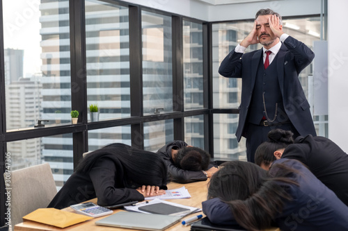 Cuadros en Lienzo Moody or stress boss with lazy or tired teamwork sleep on meeting table in offic