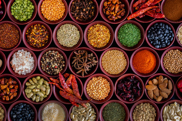 small wooden bowls of dried spices for cooking