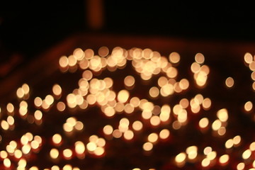 Wall Mural - Bokeh of the candle on the golden mounth