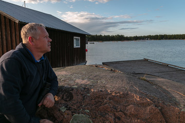 Beautiful evening. A man on vacation looks into the distance