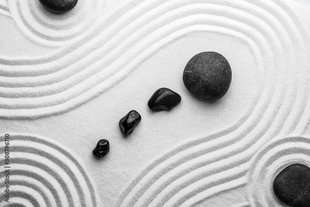 Black stones on sand with pattern, top view. Zen, meditation, harmony - obrazy, fototapety, plakaty 