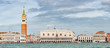 Panoramic view of Doge Palace, Campanile and San Marco square from busy Grand Canal water during evening, Venice, Italy, summer time