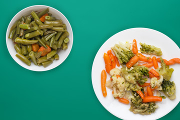  Provencal vegetables on a white plate. fried vegetables on a plate a colored background. Vegetarian food. healthy food top view