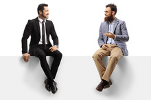 Man In A Suit And A Bearded Man Sitting On A Blank Panel And Talking