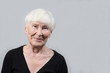 © Александр Поташев - Portrait of an elderly woman on a gray background . Close up.