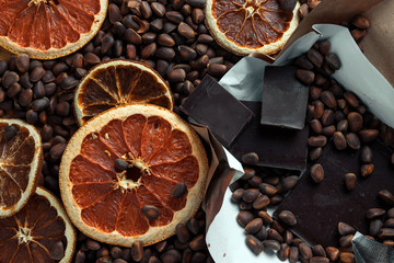 brown background of chocolate, nuts and dried citrus