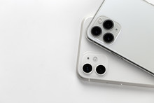 Two smartphones close-up on a white background.