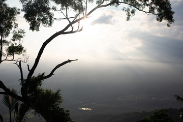 Beautiful top view with sun rays from under the clouds. Magnificent and tropical landscape in Bali, Indonesia.