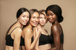 © Beauty Agent Studio - Multi racial Group of Womans with diffrent types of skin standing together and looking on camera. Diverse ethnicity women - Caucasian, African and Asian against beige background