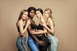© Beauty Agent Studio - Multi Ethnic Group of Womans with diffrent types of skin standing together and looking on camera. Diverse ethnicity women - Caucasian, African and Asian against beige background