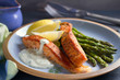 © freeskyline - Delicious cooked salmon fish fillets with asparagus and lemon wedges