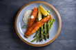 © freeskyline - Delicious cooked salmon fish fillets with asparagus and lemon wedges