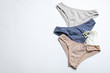 Women's underwear and flowers on white background, flat lay
