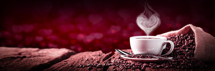 coffee with heart shaped steam on old weathered table and red heart bokeh background - valentine's d