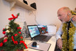 © Neil - Self employed man at Christmas,getting drunk and acting silly on his computer and having fun with a work colleague.