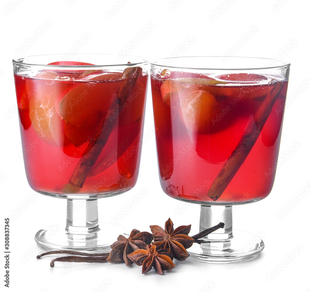 Glasses of tasty mulled wine on white background