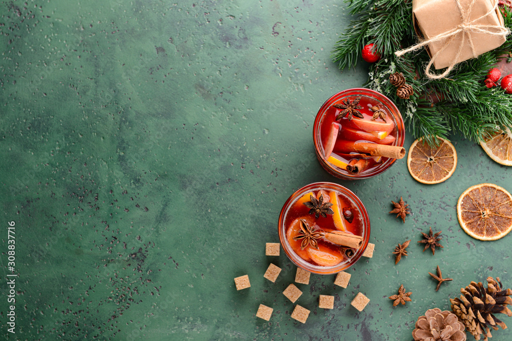 Christmas composition with tasty mulled wine on color background