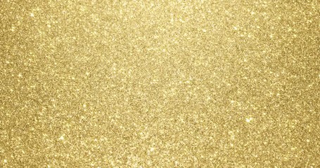 Wall Mural - Gold glitter background with sparkling texture. Golden shimmering light, stars sequins sparks and glittering glow foil background