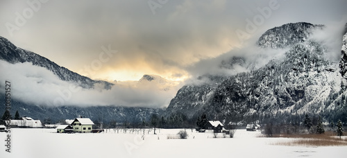 Fotografía Typical view of small alps village from window of train in snowy winter day