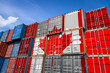 © Виталий Сова - The national flag of Canada on a large number of metal containers for storing goods stacked in rows on top of each other. Conception of storage of goods by importers, exporters