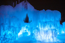 Gigantic  Icicles Frozen Over An Ice Castle On A Bitter Cold Night In Winter