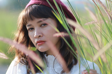 Asian woman portrait in the grass filed vintage color tone