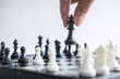 © Ngampol - Business woman playing chess and thinking strategy about crash overthrow the opposite team and development analysis for win and successful
