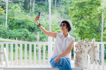 Tourists, Asian woman, selfies and fun taking pictures with mobile phones in tourist attractions