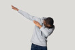Happy young african american guy in sportswear making dab gesture.