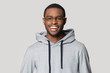 © fizkes - Smiling black male student in stylish hoodie looking at camera.